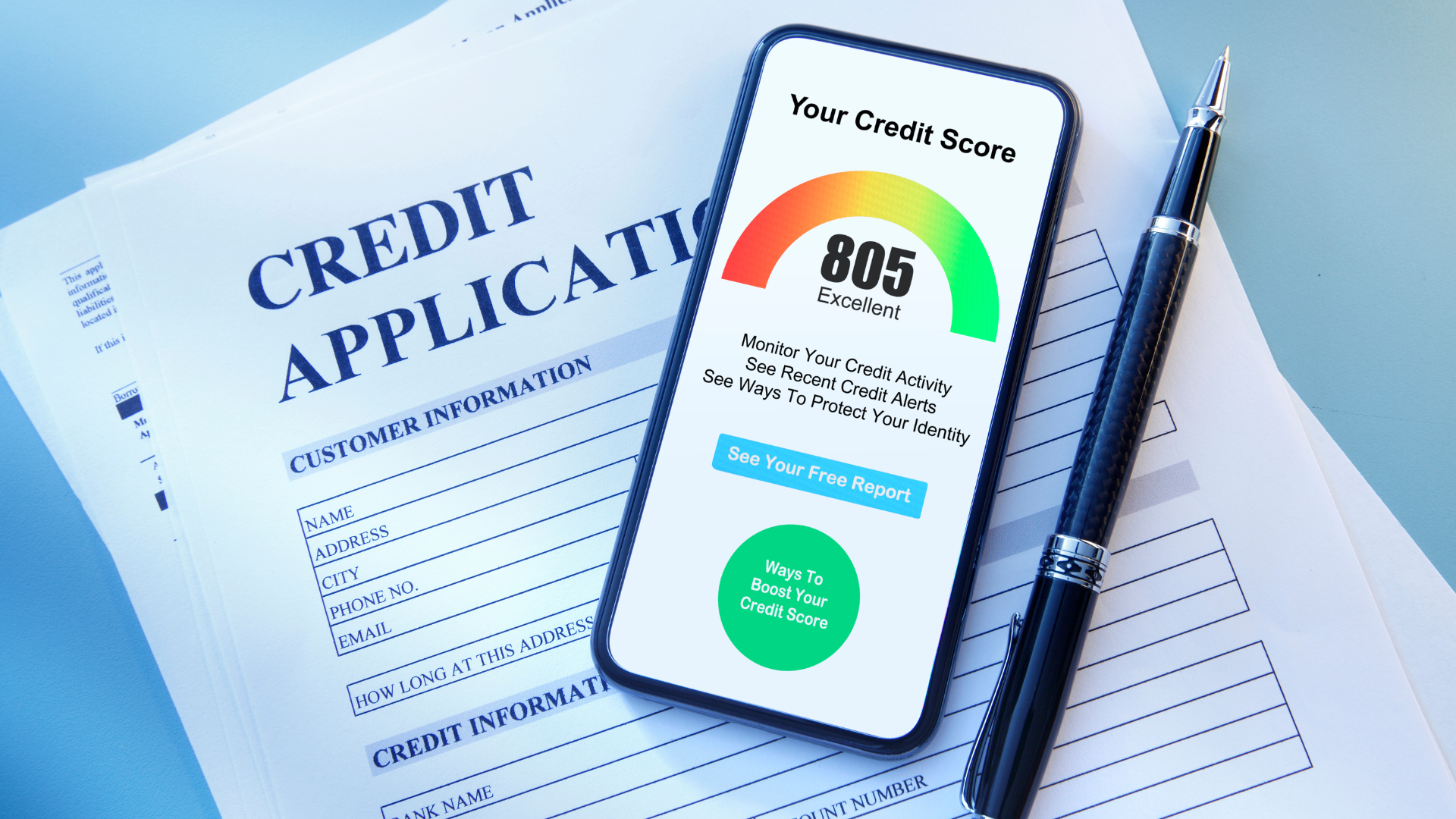 Smartphone showing a credit score of 805 on a colorful gauge next to a credit application form and a pen.