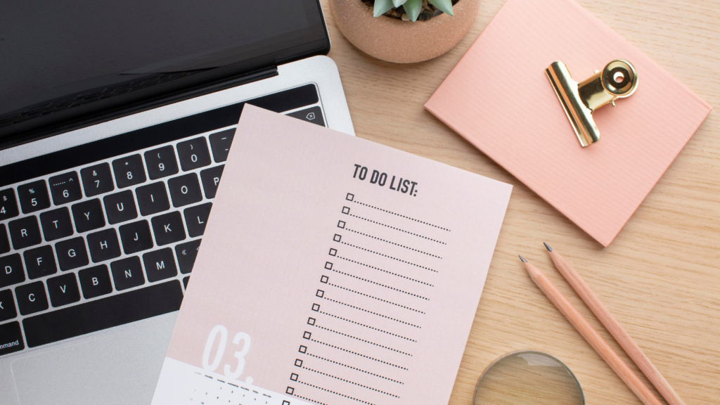 Gina Webb Accounting scene featuring a pink to-do list, a laptop, and pencils on a warm wooden desk, emphasizing organization and workflow
